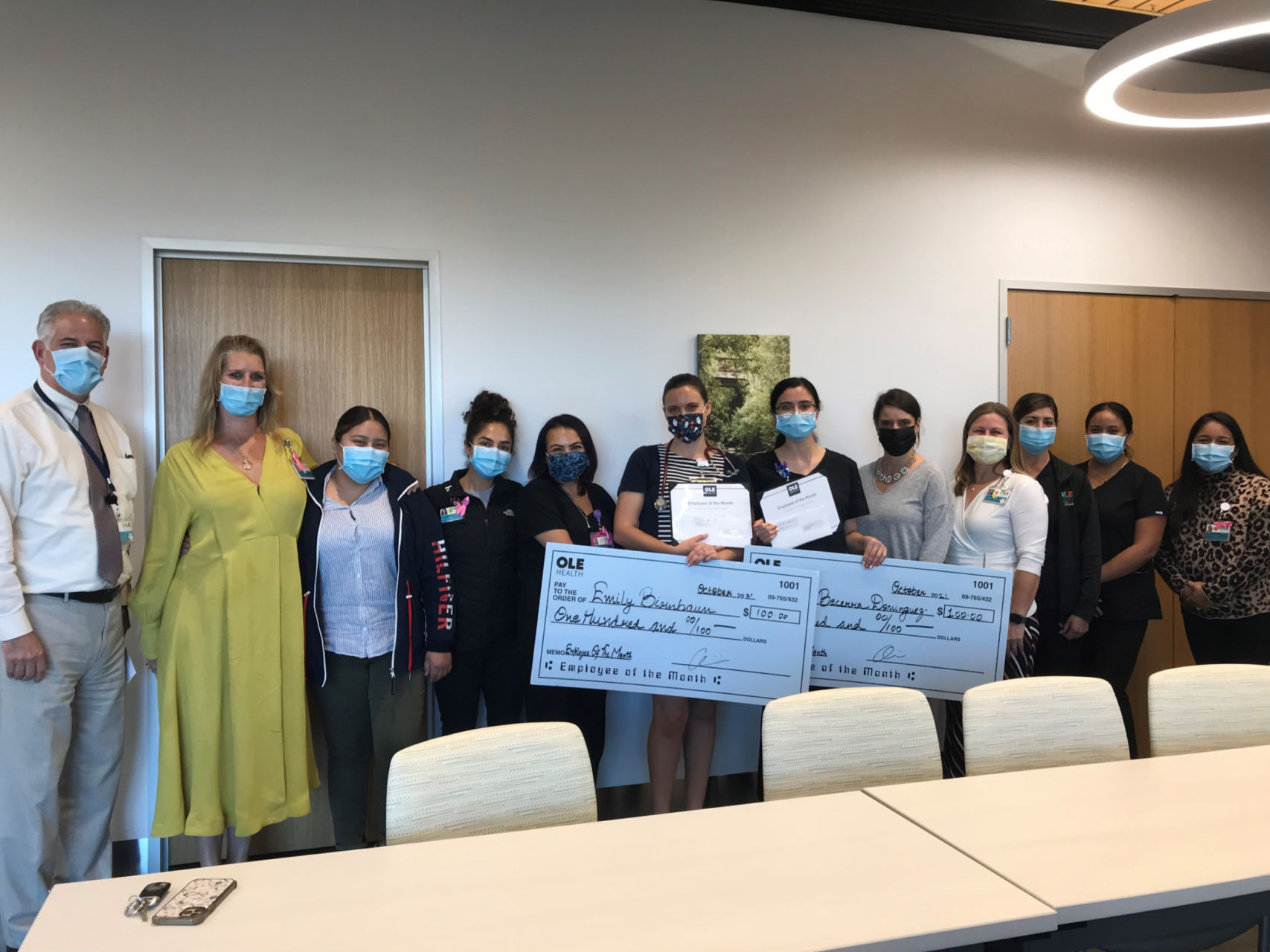 Group photo with Emily and Cecilia holding their giant checks